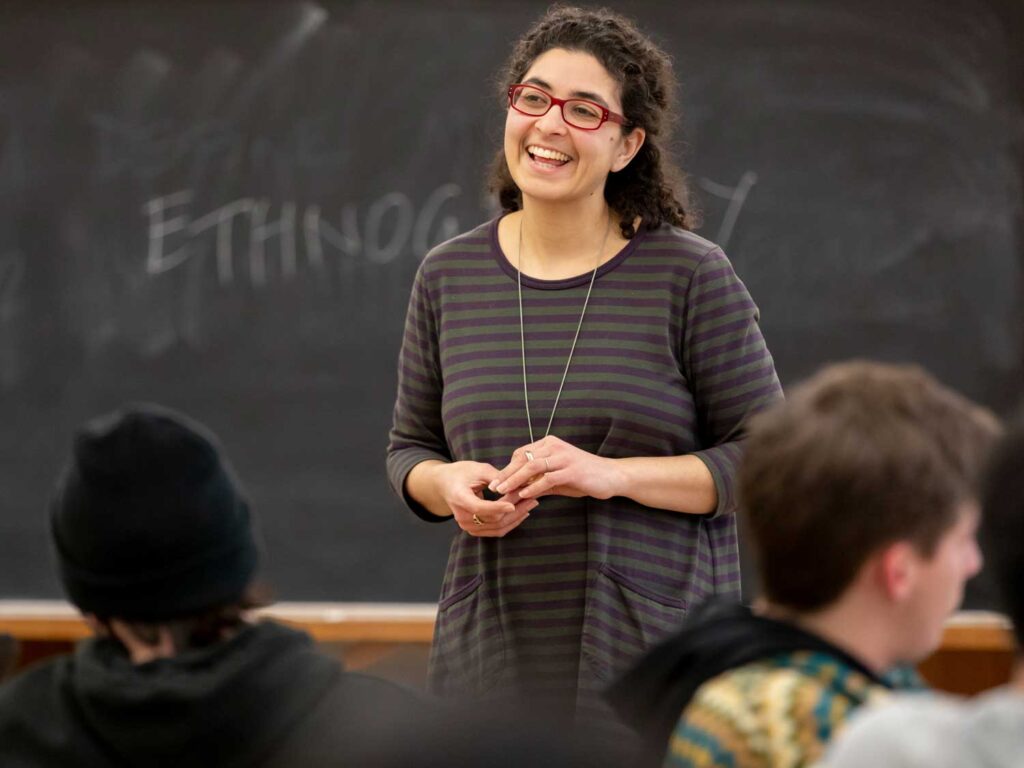Professor Denise Ramsey smiling in front of a class.